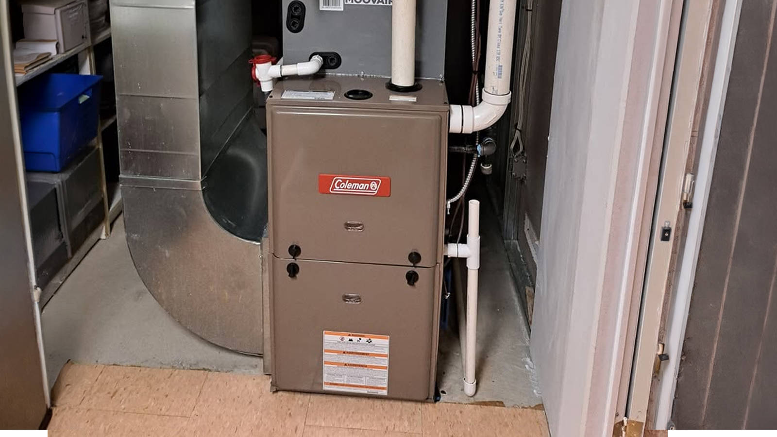 A Coleman gas furnace unit set up in a basement area ready for annual furnace maintenance.